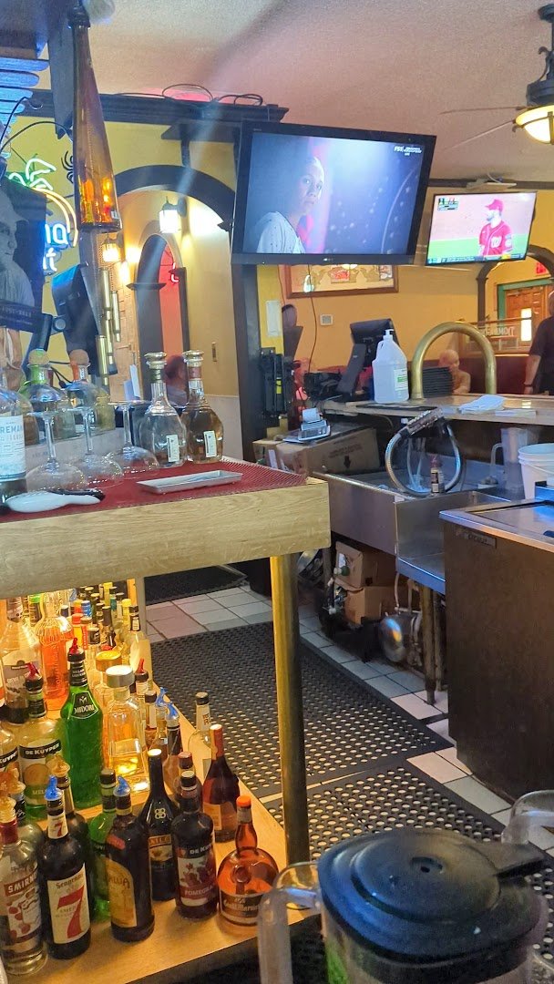 Shared dishes, drinks, and table service in a cozy dining room.